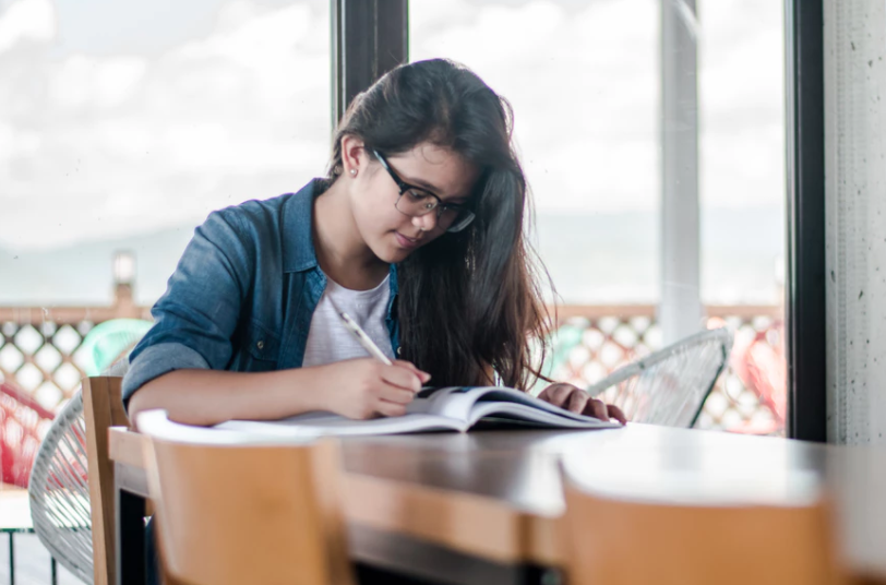 Girl studying at dining room table